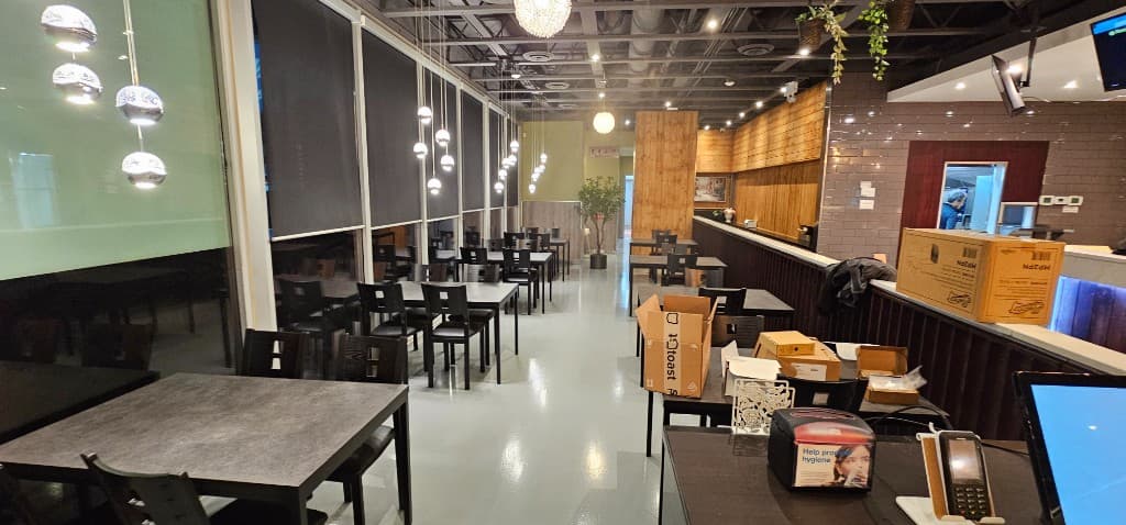 SizzlePan dining space and service area with brick and wood details